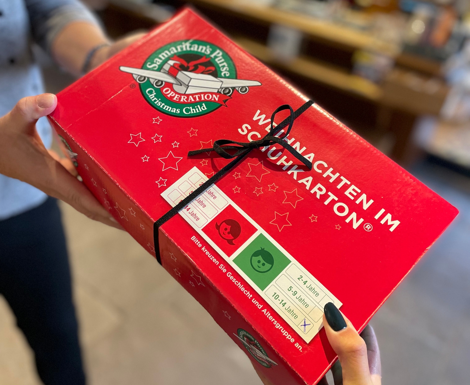 Roter Geschenkekarton wird übergeben