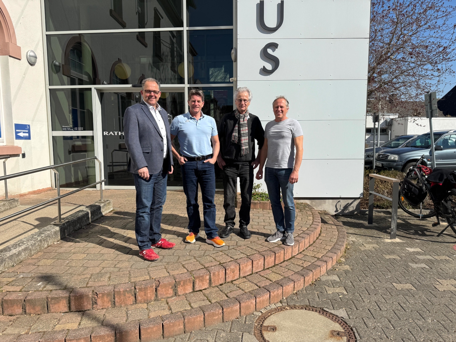 Gruppenfoto mit dem Bürgermeister und drei Beratern vorm Eltviller Rathaus